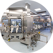 Automated drug product filling line contained in an ISO 5/Grade A isolator, sitting within an ISO 8/Grade D clean room